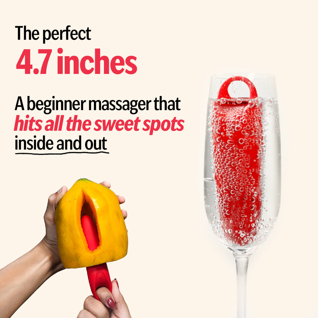 Red Candy beginner massager, 4.7 inches, shown in papaya and glass of water.