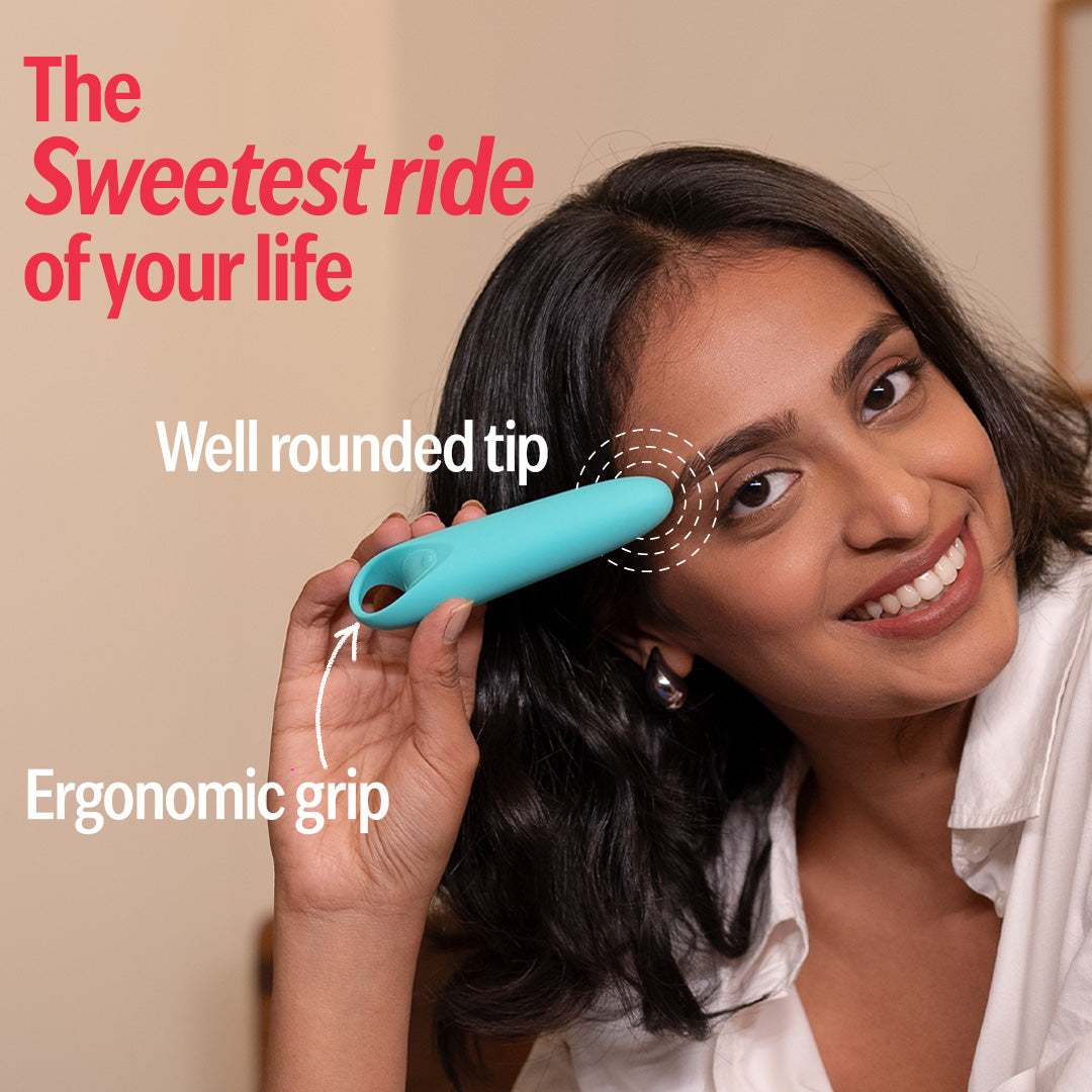 Smiling woman holding blue handheld massager with ergonomic grip and rounded tip