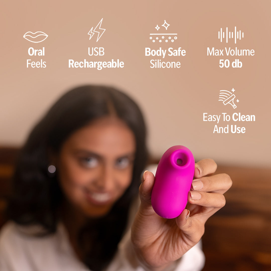 Woman holding LIT suction massager in pink showing features like USB rechargeable, body safe silicone and easy to clean.