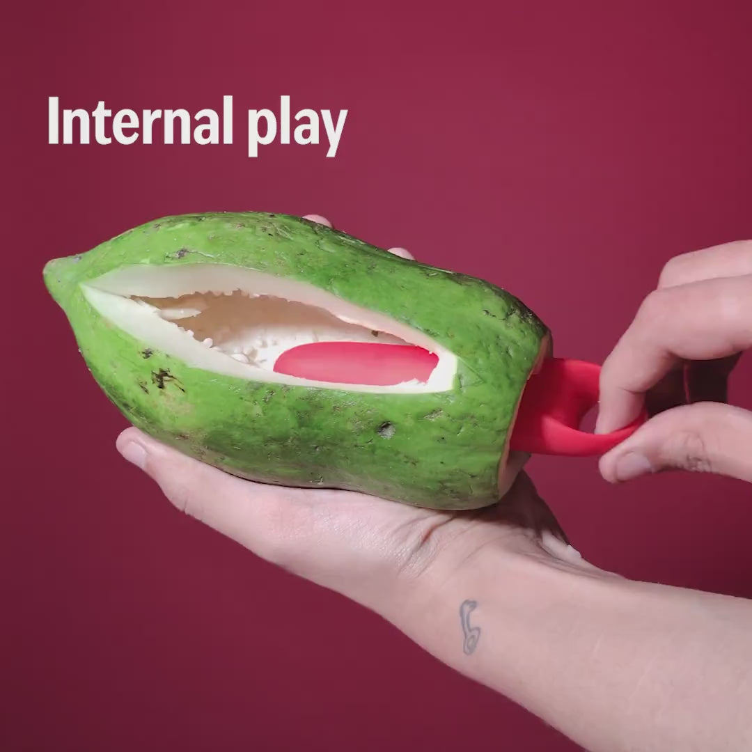 Red Candy handheld massager shown for internal play using a papaya demonstration