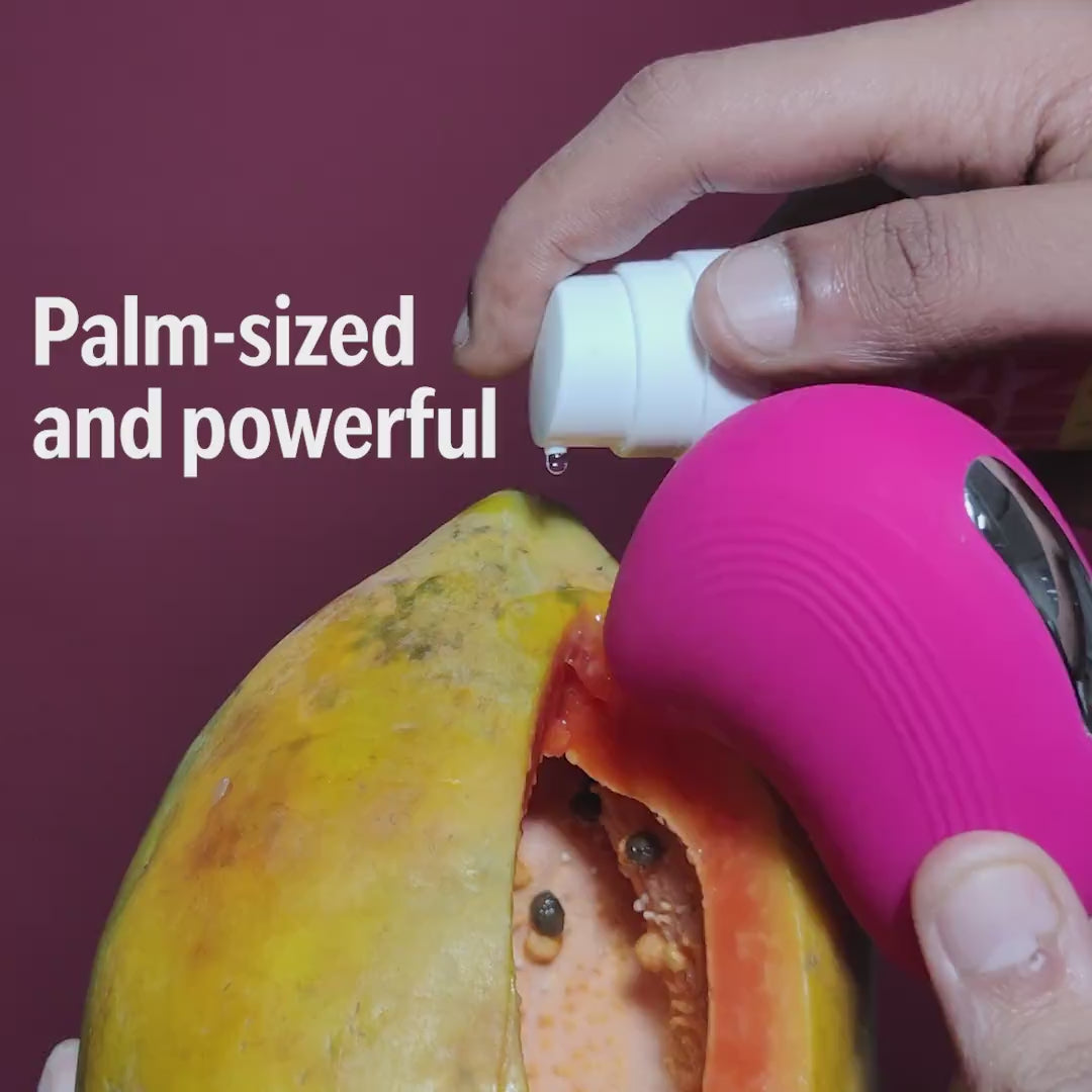 Pink LIT suction massager shown palm-sized with lube for powerful pleasure.
