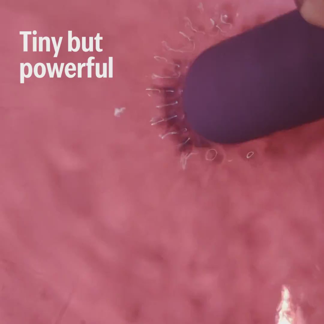 plum bullet massager shown close-up in action