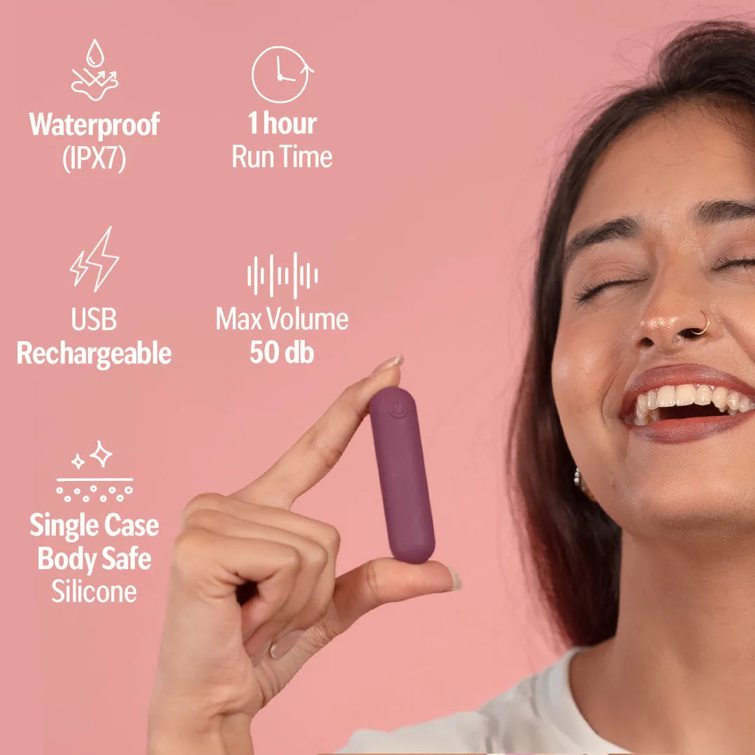 Hand holding rocket bullet massager with features shown