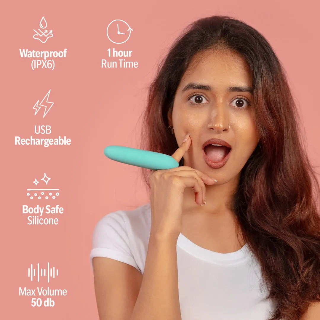 Woman holding a Blue Candy handheld massager with waterproof, USB 
rechargeable, body-safe silicone features.