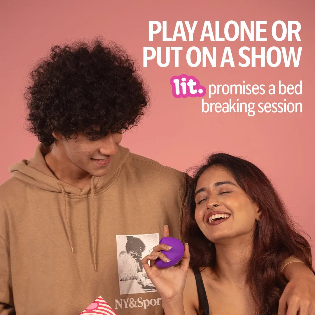 Couple smiling while holding LIT suction massager, designed for solo or partner play.