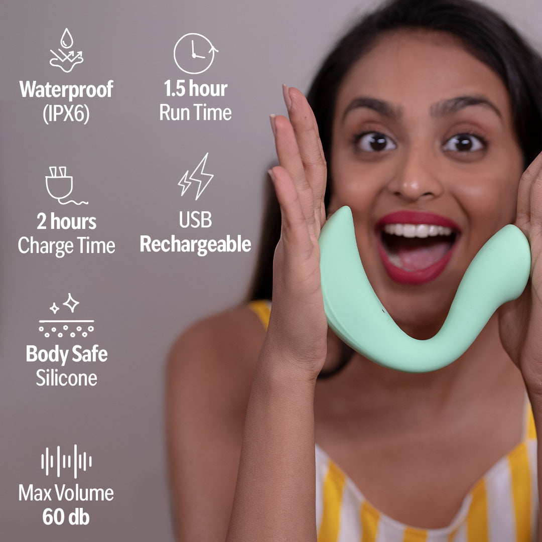 Smiling woman holding OG massager for women with waterproof, rechargeable, and body-safe silicone features listed of left. 