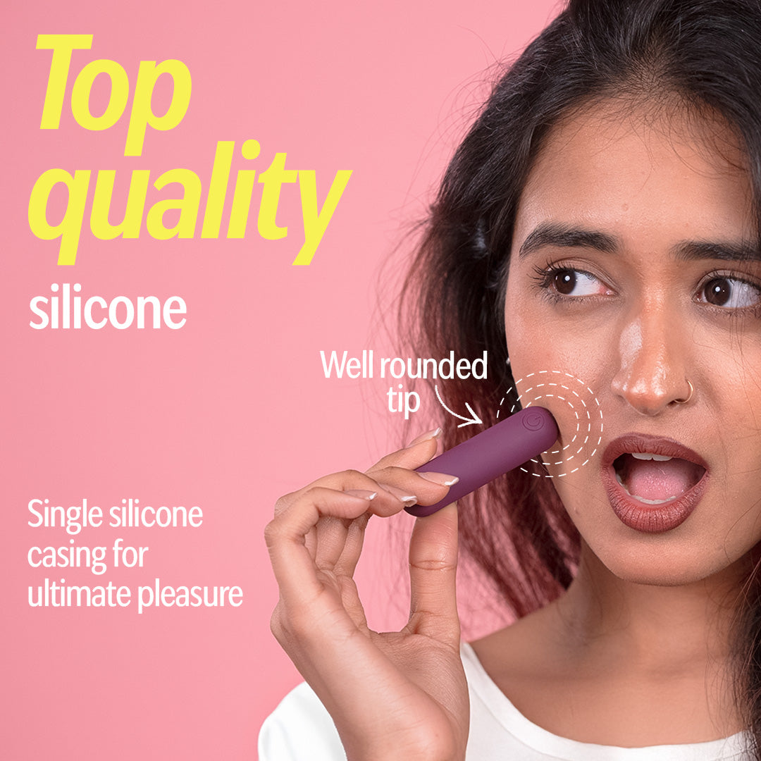 Woman holding plum bullet massager made of medical grade silicone