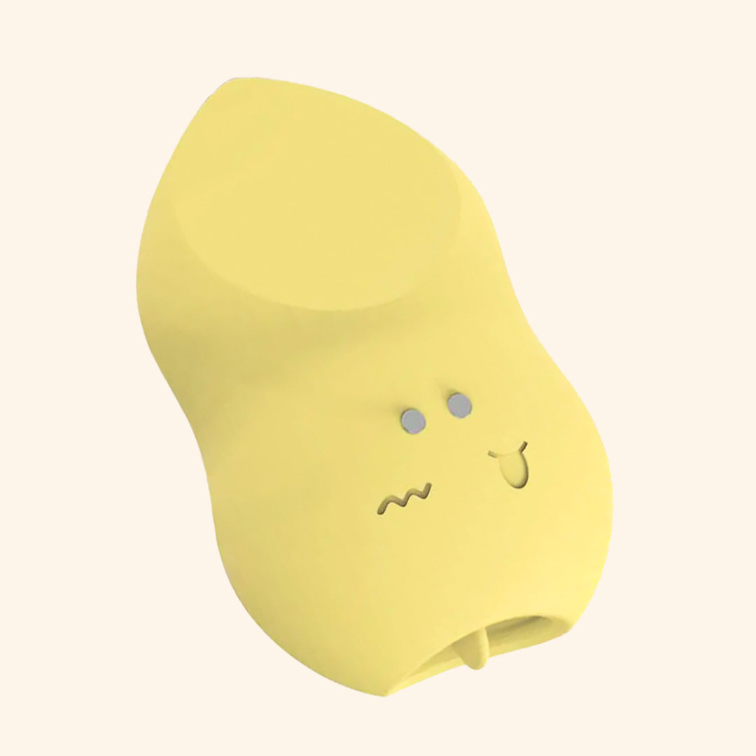 Yellow tongue massager with plain background