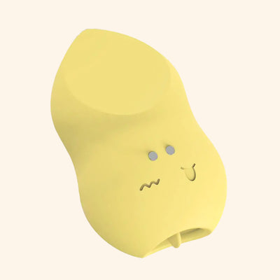 Yellow tongue massager with plain background